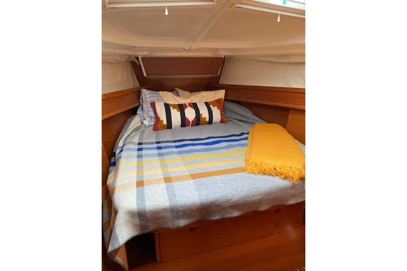 Kolibri Yacht Photos Pics Cozy cabin interior of 2006 Jeanneau Sun Odyssey 45 with colorful bedding.