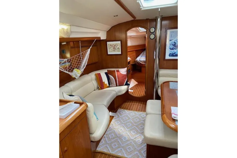 Kolibri Yacht Photos Pics Interior of 2006 Jeanneau Sun Odyssey 45 yacht with cozy seating and nautical decor.