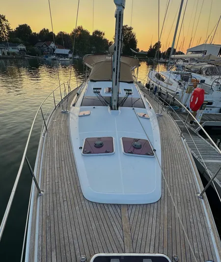 Star IV Yacht Photos Pics 2010 Jeanneau Sun Odyssey 50 DS sailboat docked at sunset, featuring a spacious deck.
