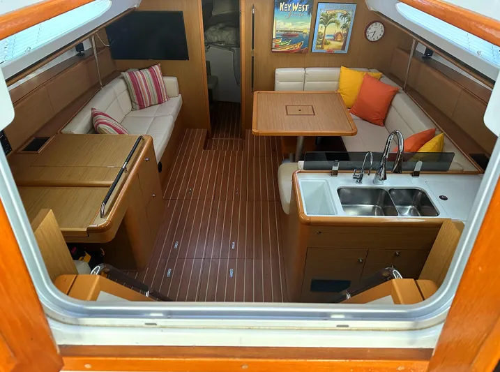 Star IV Yacht Photos Pics Interior of 2010 Jeanneau Sun Odyssey 50 DS yacht with modern furnishings and wood finish.