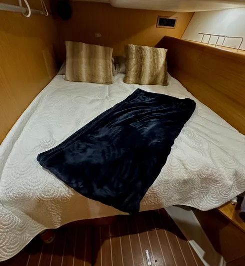 Star IV Yacht Photos Pics Cozy cabin interior of 2010 Jeanneau Sun Odyssey 50 DS with bed and pillows.