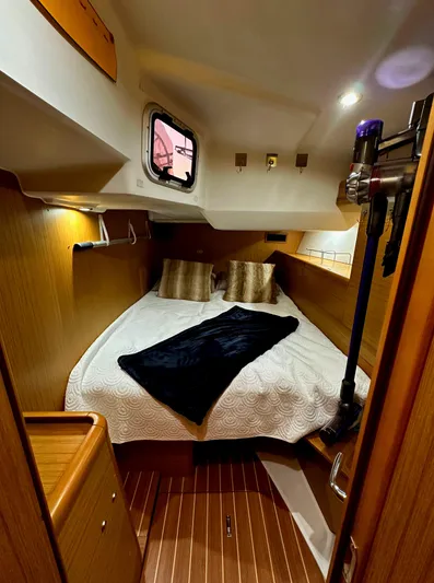 Star IV Yacht Photos Pics Cozy cabin interior of 2010 Jeanneau Sun Odyssey 50 DS sailboat with elegant bedding.