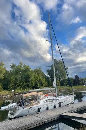 Star IV Yacht Photos Pics 2010 Jeanneau Sun Odyssey 50 DS sailboat docked under a partly cloudy sky.