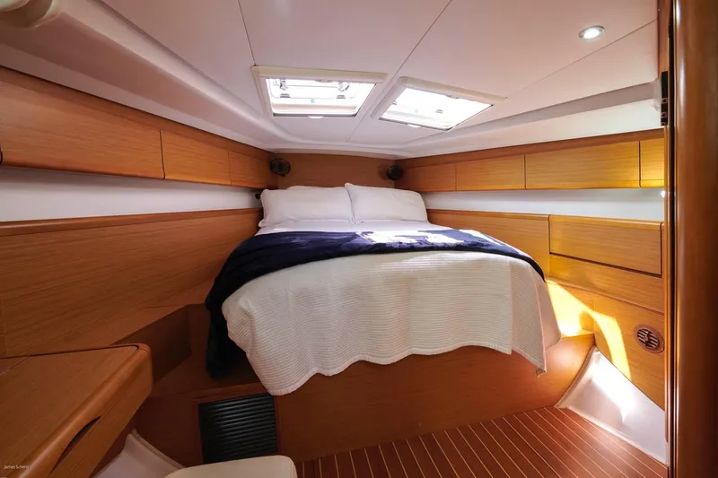 Star IV Yacht Photos Pics Luxurious cabin interior of 2010 Jeanneau Sun Odyssey 50 DS yacht, featuring cozy bedding.