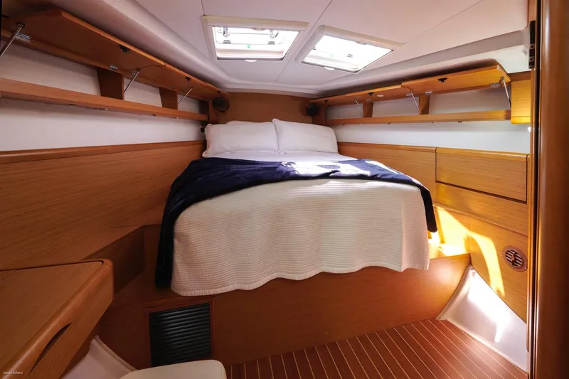 Star IV Yacht Photos Pics Cozy cabin interior of 2010 Jeanneau Sun Odyssey 50 DS with wooden finish and skylights.