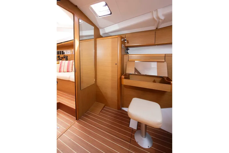 Star IV Yacht Photos Pics Interior of 2010 Jeanneau Sun Odyssey 50 DS, featuring wooden cabinetry and seating.