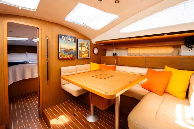 Star IV Yacht Photos Pics Interior of 2010 Jeanneau Sun Odyssey 50 DS yacht with cozy seating and vibrant decor.
