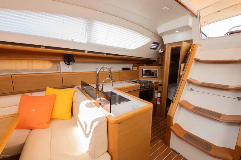 Star IV Yacht Photos Pics Interior of 2010 Jeanneau Sun Odyssey 50 DS yacht with modern kitchen and seating area.