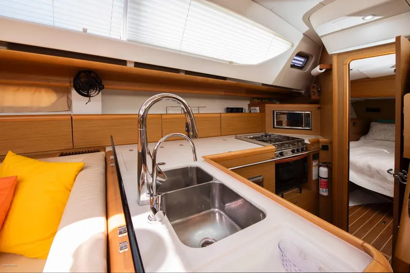 Star IV Yacht Photos Pics Interior of 2010 Jeanneau Sun Odyssey 50 DS yacht, featuring modern kitchen and cozy cabin.