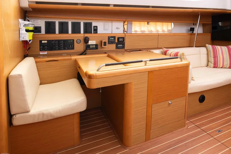 Star IV Yacht Photos Pics Interior of 2010 Jeanneau Sun Odyssey 50 DS yacht with navigation station and seating area.