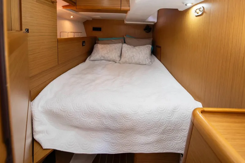 Star IV Yacht Photos Pics Cozy cabin interior of 2010 Jeanneau Sun Odyssey 50 DS with comfortable bedding.