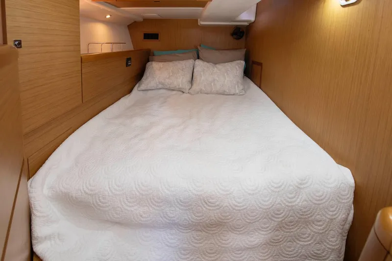 Star IV Yacht Photos Pics Cozy cabin interior of 2010 Jeanneau Sun Odyssey 50 DS with comfortable bedding.