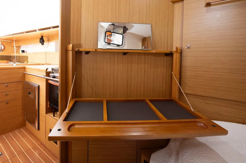 Star IV Yacht Photos Pics Interior of 2010 Jeanneau Sun Odyssey 50 DS yacht with wooden cabinetry and foldable desk.