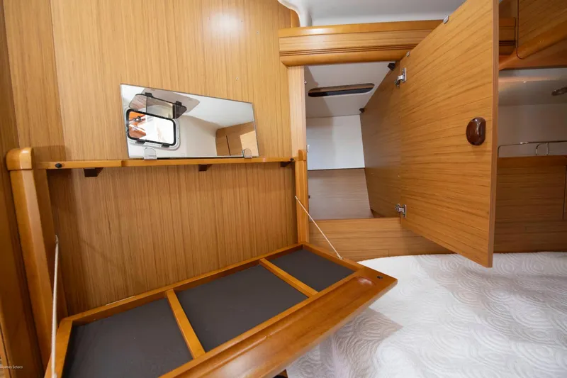 Star IV Yacht Photos Pics Interior of 2010 Jeanneau Sun Odyssey 50 DS yacht with wooden cabinetry and mirror.