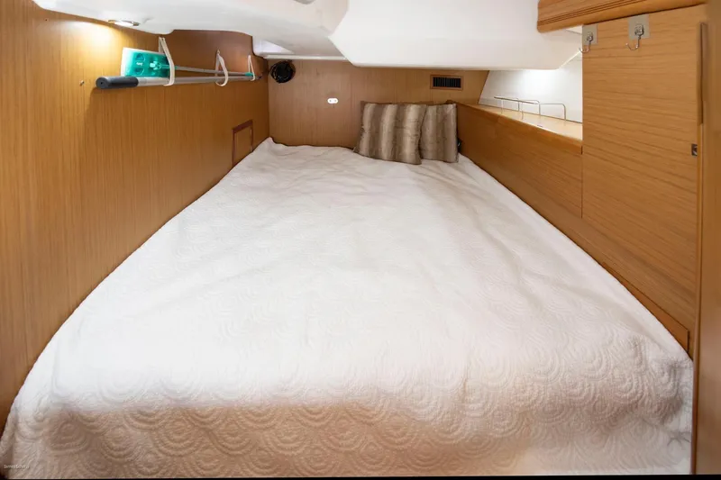 Star IV Yacht Photos Pics Cozy cabin interior of 2010 Jeanneau Sun Odyssey 50 DS with a comfortable bed.