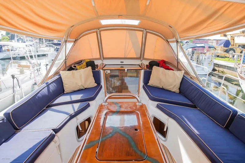 Star IV Yacht Photos Pics Jeanneau Sun Odyssey 50 DS 2010 yacht cockpit with blue cushions and orange canopy.