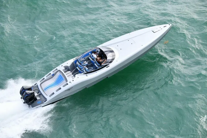  Yacht Photos Pics 2027 Canados 411 Gladiator Carbon Series speedboat cruising on turquoise waters.