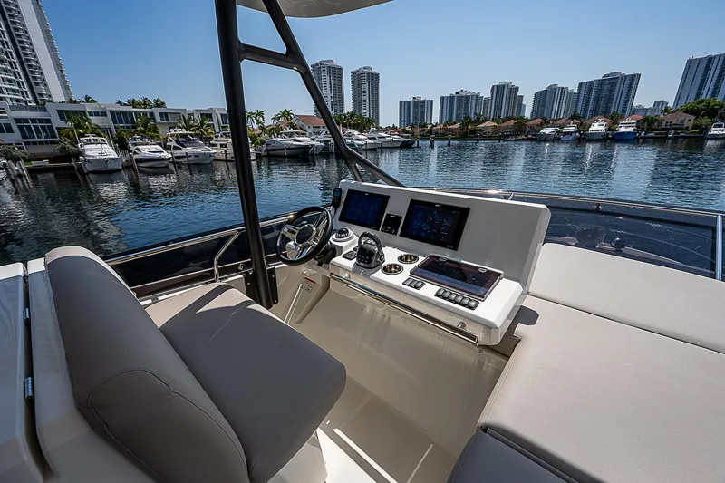 Miss K Yacht Photos Pics Flybridge helm of 2022 Prestige 520 Fly yacht with city skyline in background.