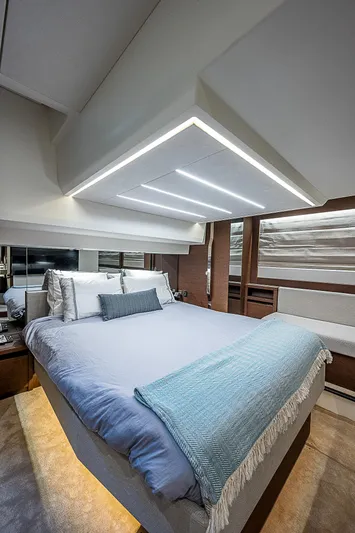 Miss K Yacht Photos Pics Luxurious bedroom interior of 2022 Prestige 520 Fly yacht with modern lighting and elegant bedding.