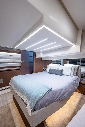 Miss K Yacht Photos Pics Luxurious bedroom interior of 2022 Prestige 520 Fly yacht with modern design and ambient lighting.