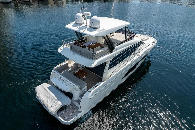 Miss K Yacht Photos Pics 2022 Prestige 520 Fly yacht on water, showcasing sleek design and spacious deck.