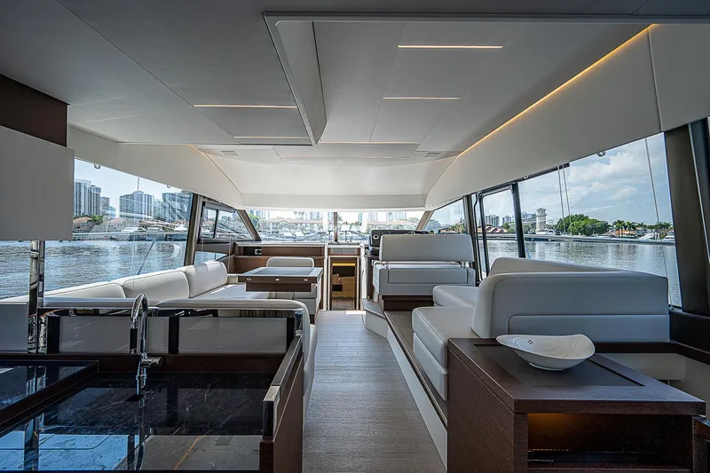 Miss K Yacht Photos Pics Luxurious interior of 2022 Prestige 520 Fly yacht with modern seating and panoramic windows.
