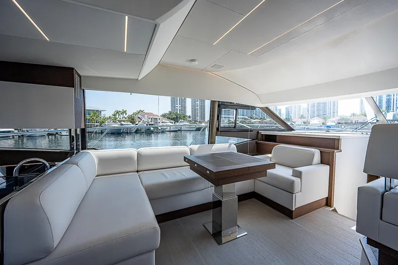 Miss K Yacht Photos Pics Luxurious interior of 2022 Prestige 520 Fly yacht with modern seating and waterfront view.