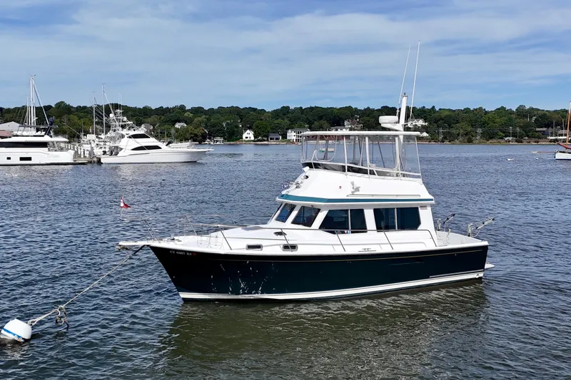 Daystar Yacht Photos Pics 2001 Sabre Sabreline 34 yacht anchored in a scenic harbor setting.