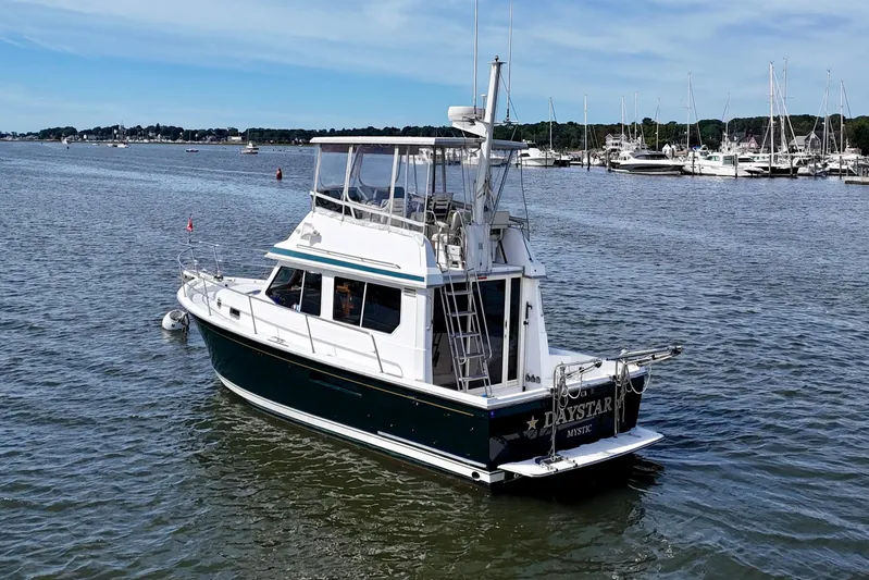 Daystar Yacht Photos Pics 2001 Sabre Sabreline 34 boat on calm water near marina.
