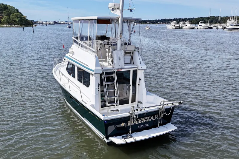 Daystar Yacht Photos Pics 2001 Sabre Sabreline 34 yacht on calm waters, featuring a spacious deck and elegant design.