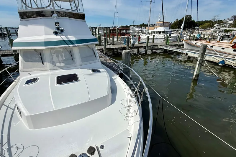 Daystar Yacht Photos Pics 2001 Sabreline 34 boat docked at marina, surrounded by water and other vessels.