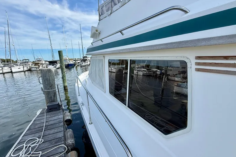 Daystar Yacht Photos Pics 2001 Sabre Sabreline 34 yacht docked at marina, reflecting boats and clear sky.