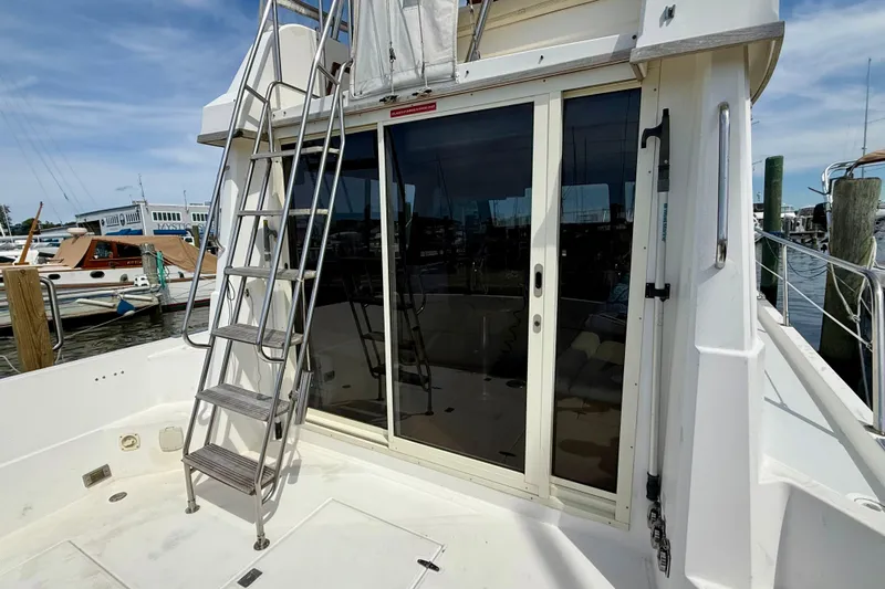 Daystar Yacht Photos Pics 2001 Sabre Sabreline 34 yacht with ladder and sliding glass doors at marina.