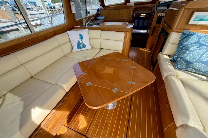 Daystar Yacht Photos Pics Luxurious interior of 2001 Sabreline 34 yacht with plush seating and elegant wooden table.