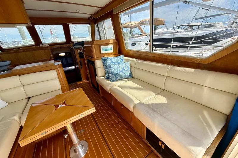 Daystar Yacht Photos Pics Interior of 2001 Sabre Sabreline 34 yacht with elegant wood and cream seating.