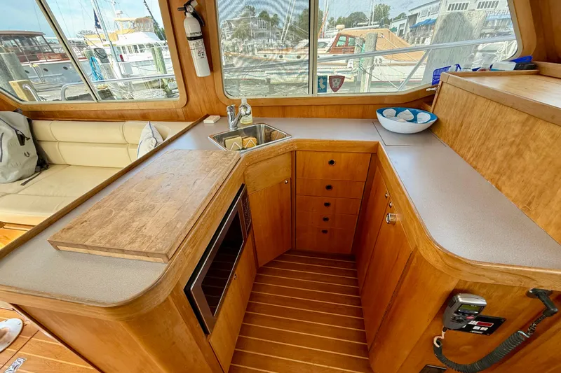 Daystar Yacht Photos Pics Interior of 2001 Sabreline 34 yacht with wooden cabinetry and compact kitchen area.