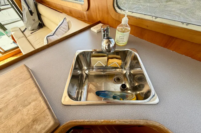 Daystar Yacht Photos Pics Compact kitchen sink area on 2001 Sabre Sabreline 34 boat with soap and sponges.