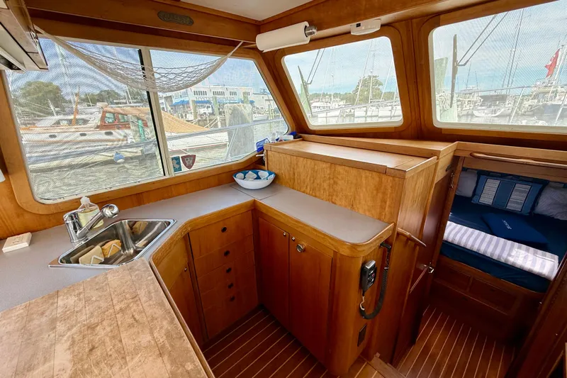 Daystar Yacht Photos Pics 2001 Sabre Sabreline 34 yacht interior with wooden cabinetry and cozy sleeping area.