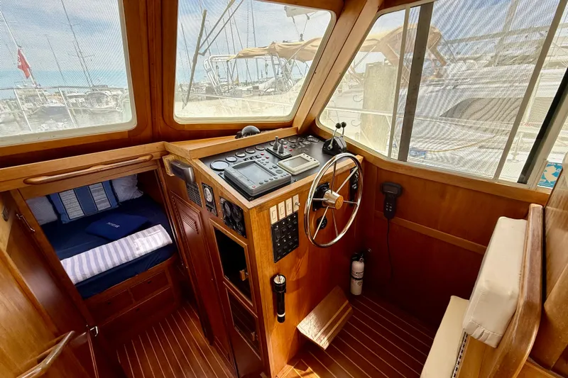 Daystar Yacht Photos Pics 2001 Sabre Sabreline 34 boat interior with wooden helm, steering wheel, and navigation controls.