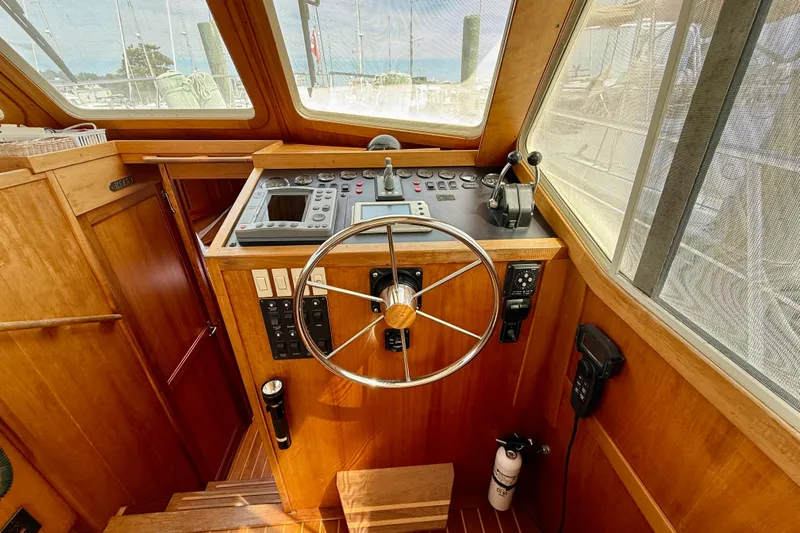 Daystar Yacht Photos Pics 2001 Sabre Sabreline 34 helm with wooden finish and navigation controls.