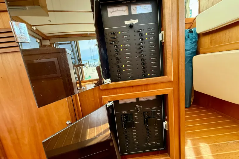 Daystar Yacht Photos Pics Electrical control panel inside 2001 Sabre Sabreline 34 boat, featuring wooden interior.