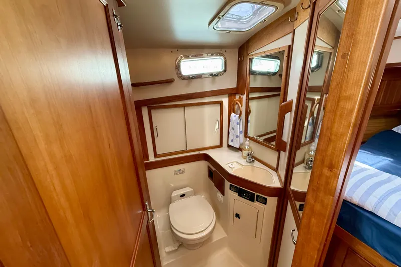 Daystar Yacht Photos Pics 2001 Sabre Sabreline 34 yacht bathroom with wood accents and compact design.