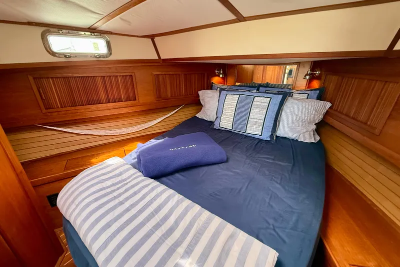 Daystar Yacht Photos Pics Cozy cabin interior of 2001 Sabre Sabreline 34 with nautical bedding and wood paneling.