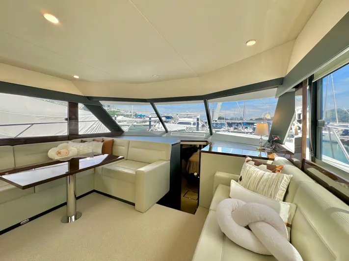 Waves III Yacht Photos Pics Luxurious interior of 2017 Maritimo M51 yacht with plush seating and panoramic windows.