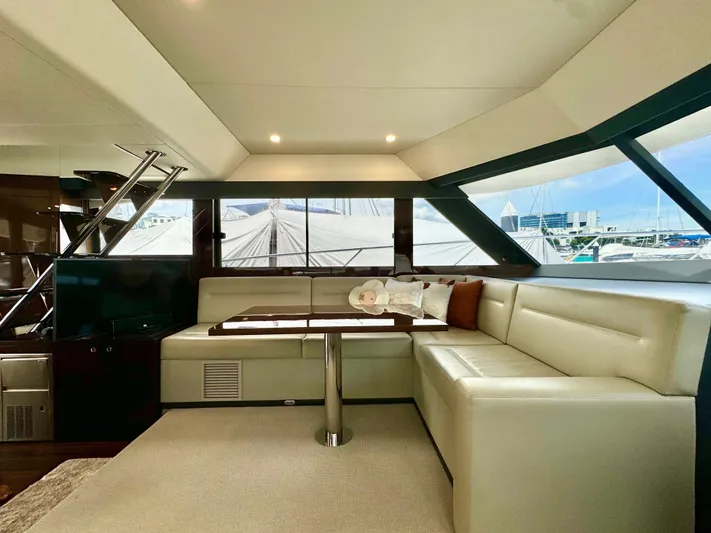 Waves III Yacht Photos Pics Luxurious interior of 2017 Maritimo M51 yacht with elegant seating and panoramic windows.