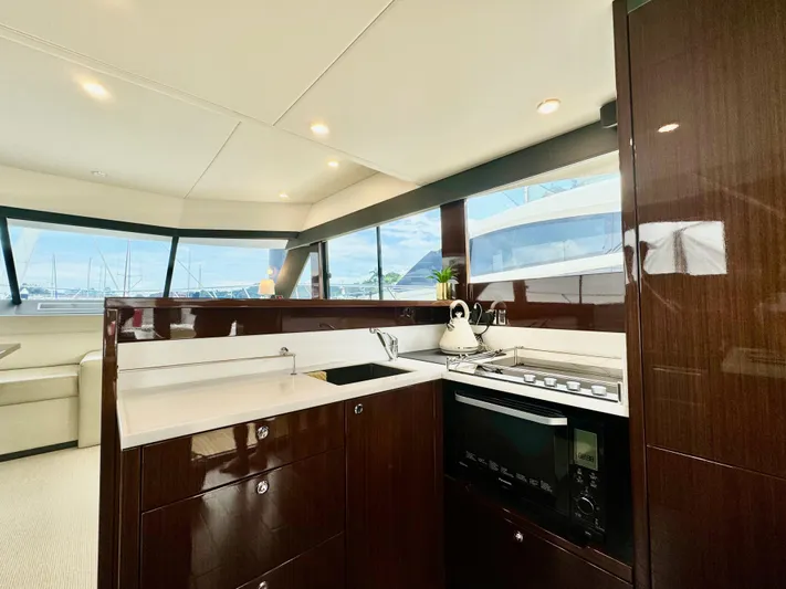Waves III Yacht Photos Pics Luxurious 2017 Maritimo M51 yacht kitchen with modern appliances and sleek wood cabinetry.
