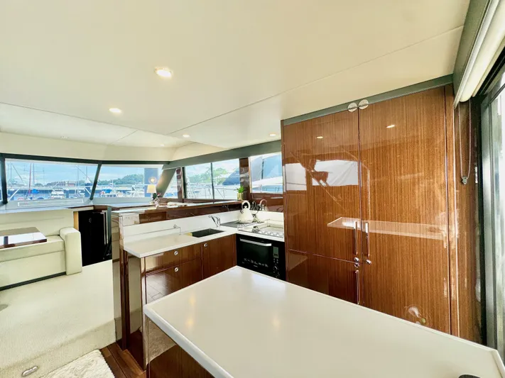 Waves III Yacht Photos Pics Luxurious interior of 2017 Maritimo M51 yacht with modern kitchen and panoramic windows.