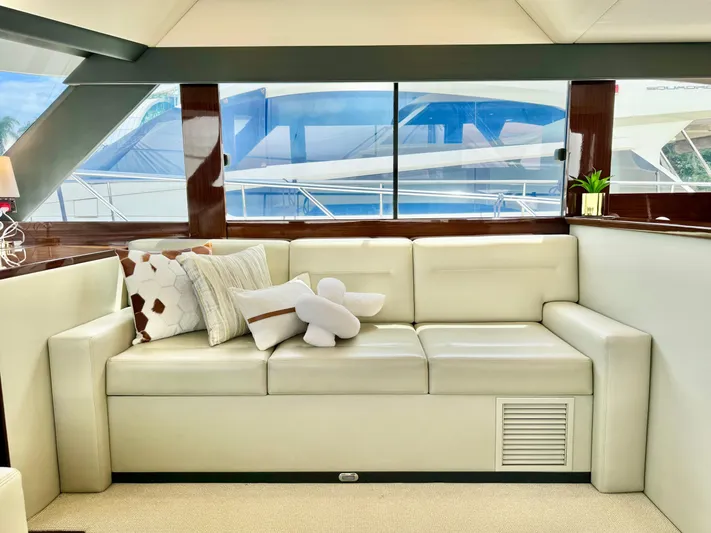 Waves III Yacht Photos Pics Luxurious interior of 2017 Maritimo M51 yacht with elegant cream sofa and decorative pillows.