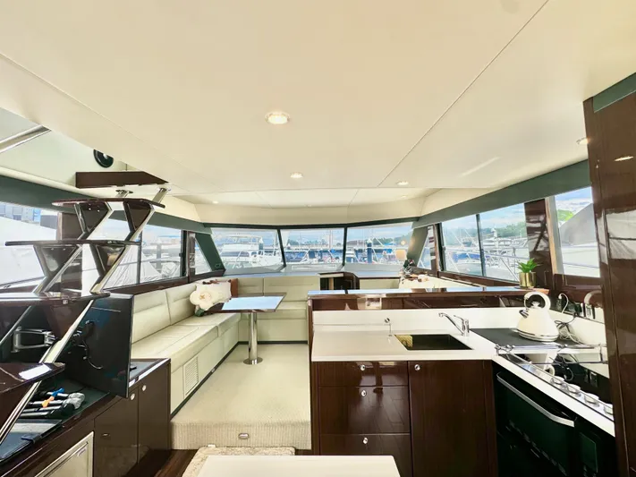 Waves III Yacht Photos Pics Luxurious interior of 2017 Maritimo M51 yacht with modern kitchen and spacious seating area.