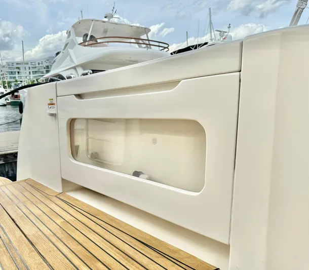 Waves III Yacht Photos Pics 2017 Maritimo M51 yacht deck with sleek white cabinetry and wooden flooring.